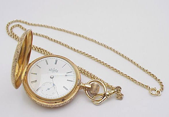 14kyg Elgin pocket watch: 14kyg Elgin pocket watch weighing 65.4 grams. Watch has bird on a branch with area for engraving. Watch is in good running condition and has gold filled fob.