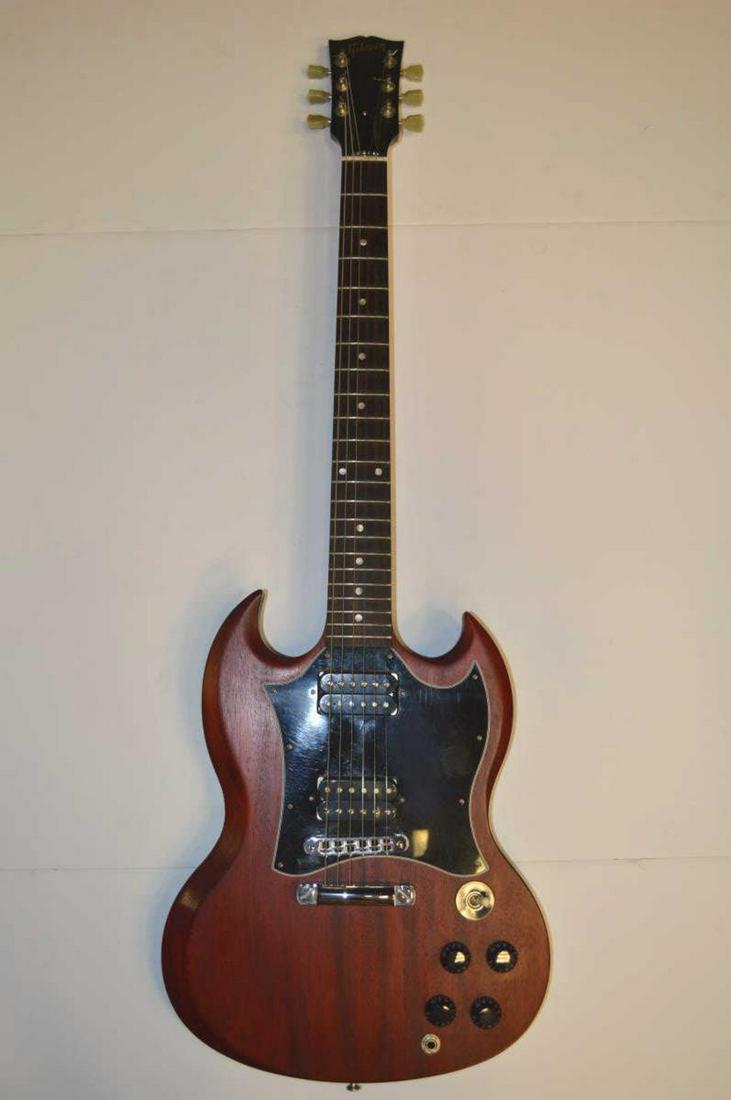 2008 Gibson SG Electric Guitar: 2008 Gibson SG Electric Guitar. Red stained Mahogany with dual humbuckers, mother of pearl inlay and rosewood fret board on a rounded neck, serial # 016480467, with hard shell case, 40"l. Gently used