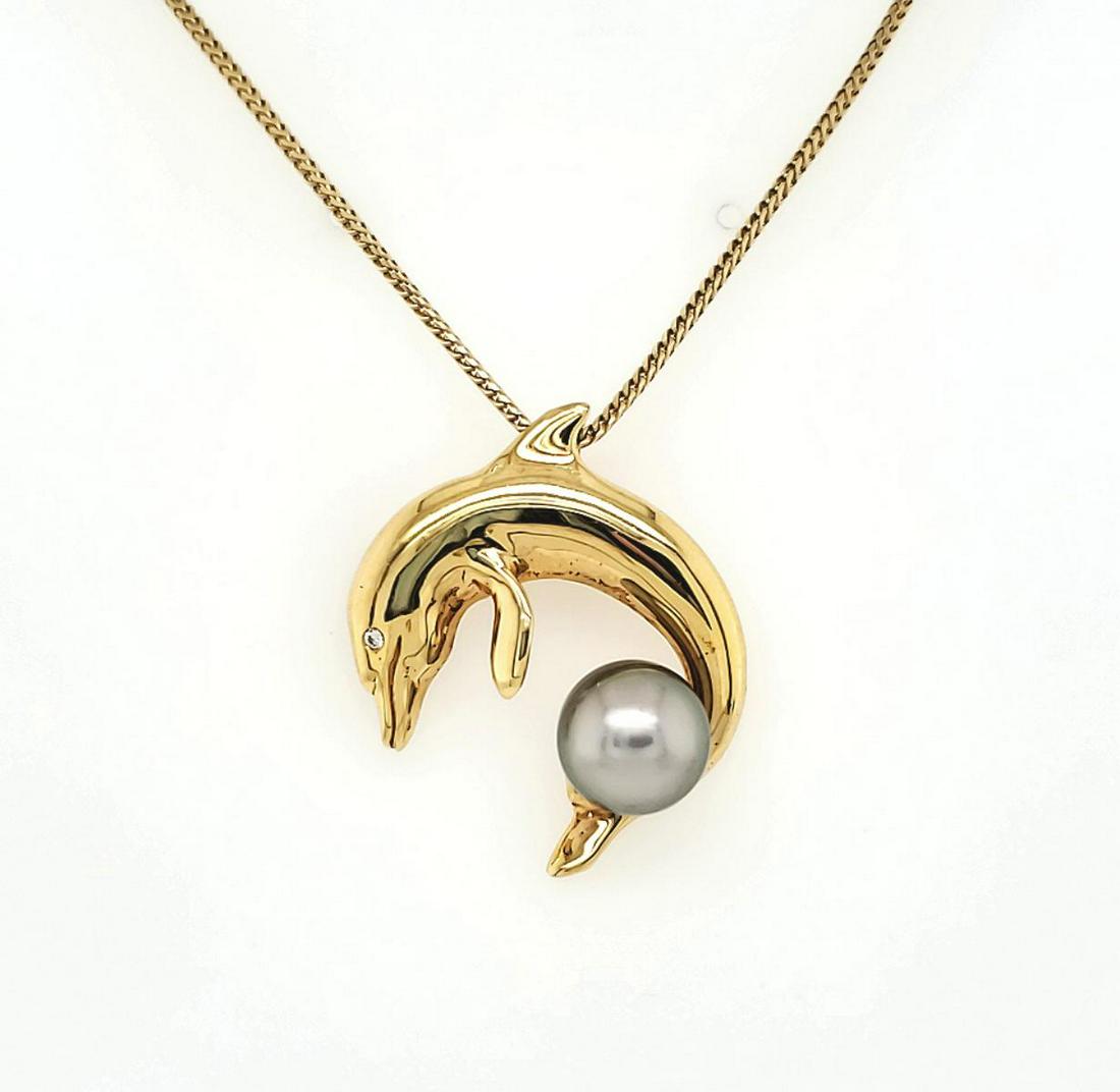 18kt yellow gold Tahitian pearl dolphin pendant: Ladies 18kt yellow gold dolphin pendant featuring a 9mm Tahitian pearl and accented with a diamond in the eye. Hanging from a 14kt yellow gold 16" chain. Pendant weight 5.0 grams. Chain weight 3.5 gra