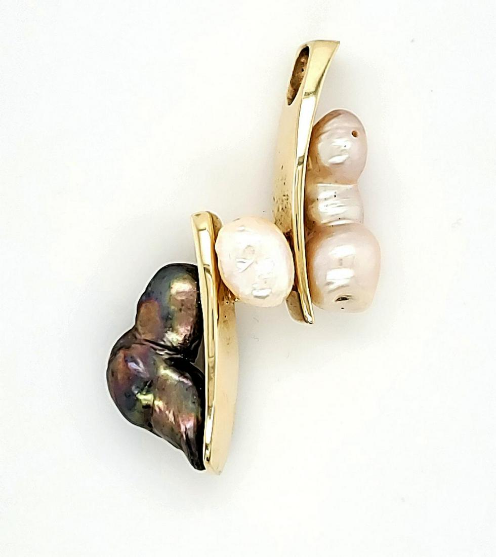 Black and White Baroque Pearl Slide Pendant: 14kt yellow gold slide pendant with black and white baroque pearls, 2" long. Weight 18.3gr.