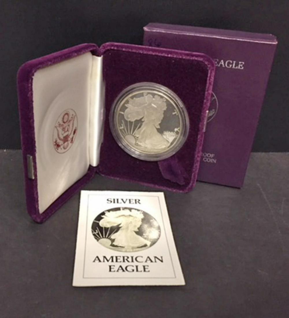 1986 Proof Silver American Eagle 1 Oz, Box & COA: 1986 Proof Silver American Eagle 1 Oz, Box & COA. First year of issue for this iconic coin, this proof struck version offers deep mirrored fields and frosty cameo devices. Coin is one-ounce of .999 fi