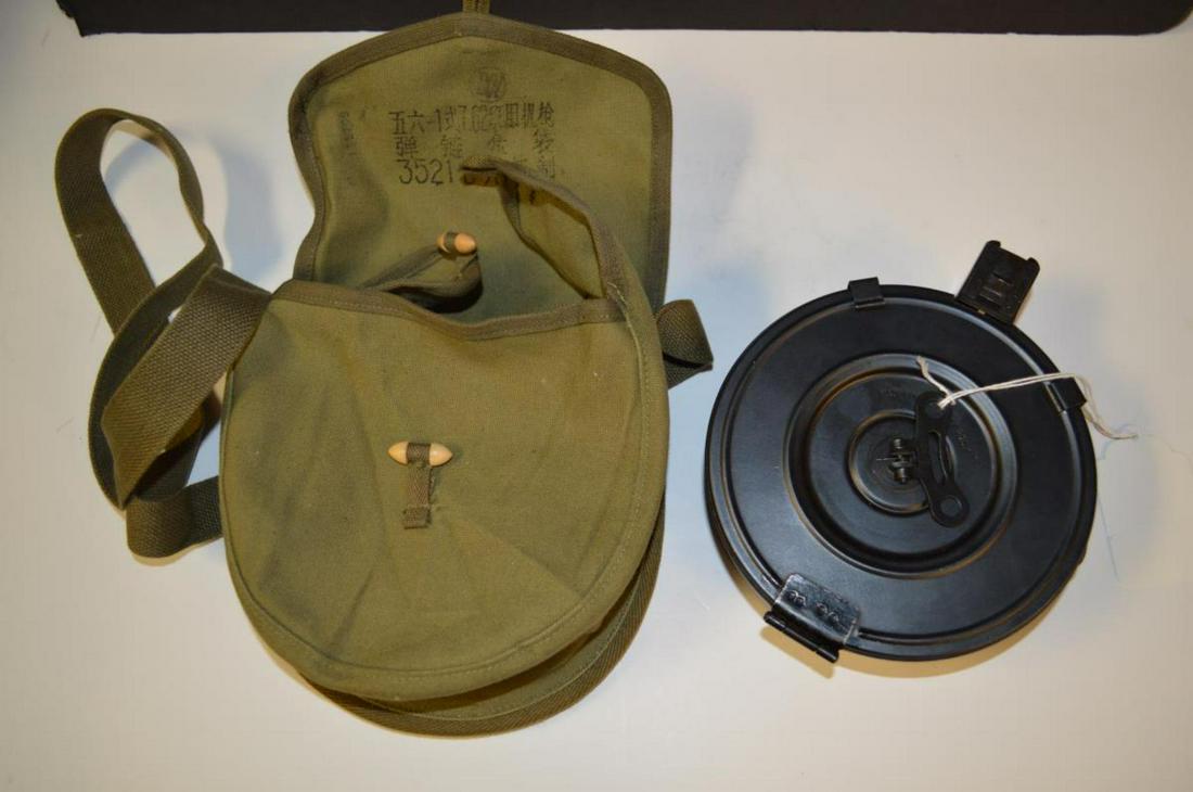 AK-47 Metal Drum Magazine 75 Round 7.62 x 39 Case: AK-47 Metal Drum Magazine 75 Round 7.62 x 39 Marked Made in China by Poly with Chinese Type Canvas Case with Wood Toggle Type Closures. Black finish & appears to be in excellent condition.