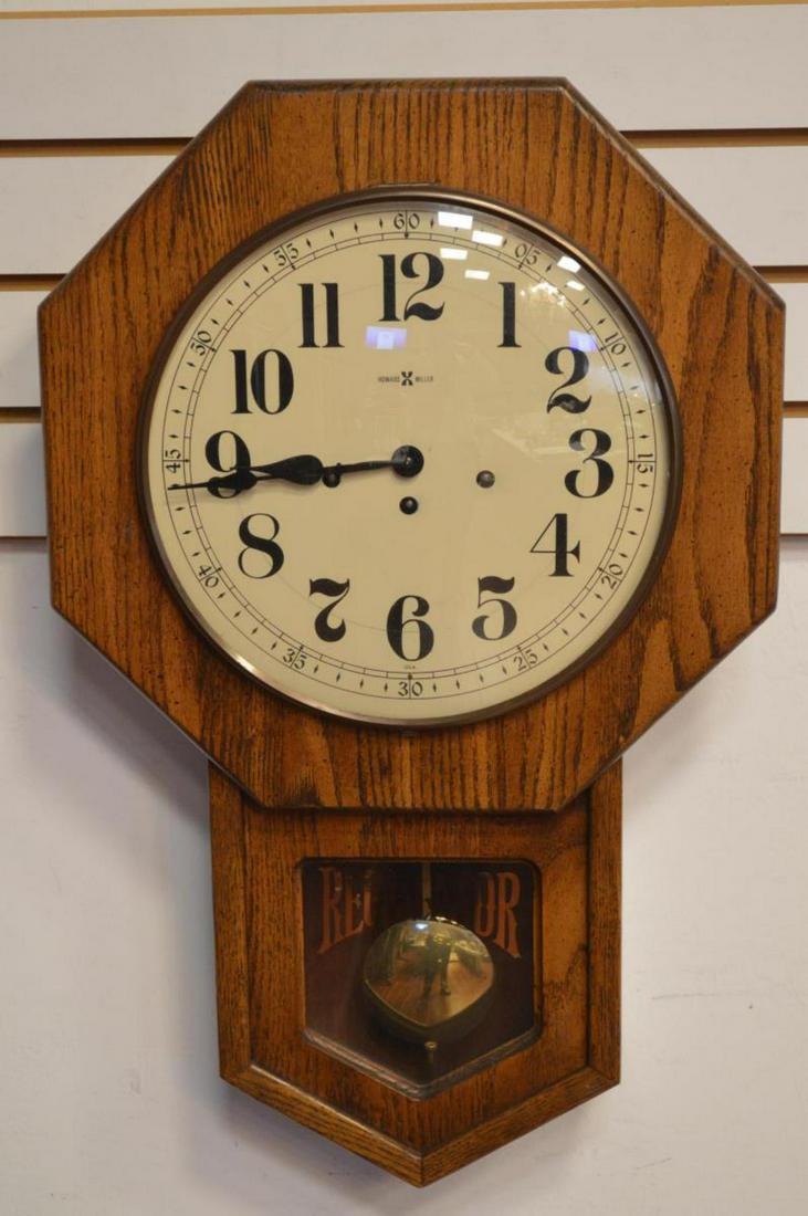 Howard Miller Regulator Oak Wall Clock M# 612533: Howard Miller Regulator Pendulum Oak Wall Clock Model# 612533 This wonderful clock has a black on cream dial with Arabic numerals & three winding lugs. (w key). The glass window has a painted imprinte