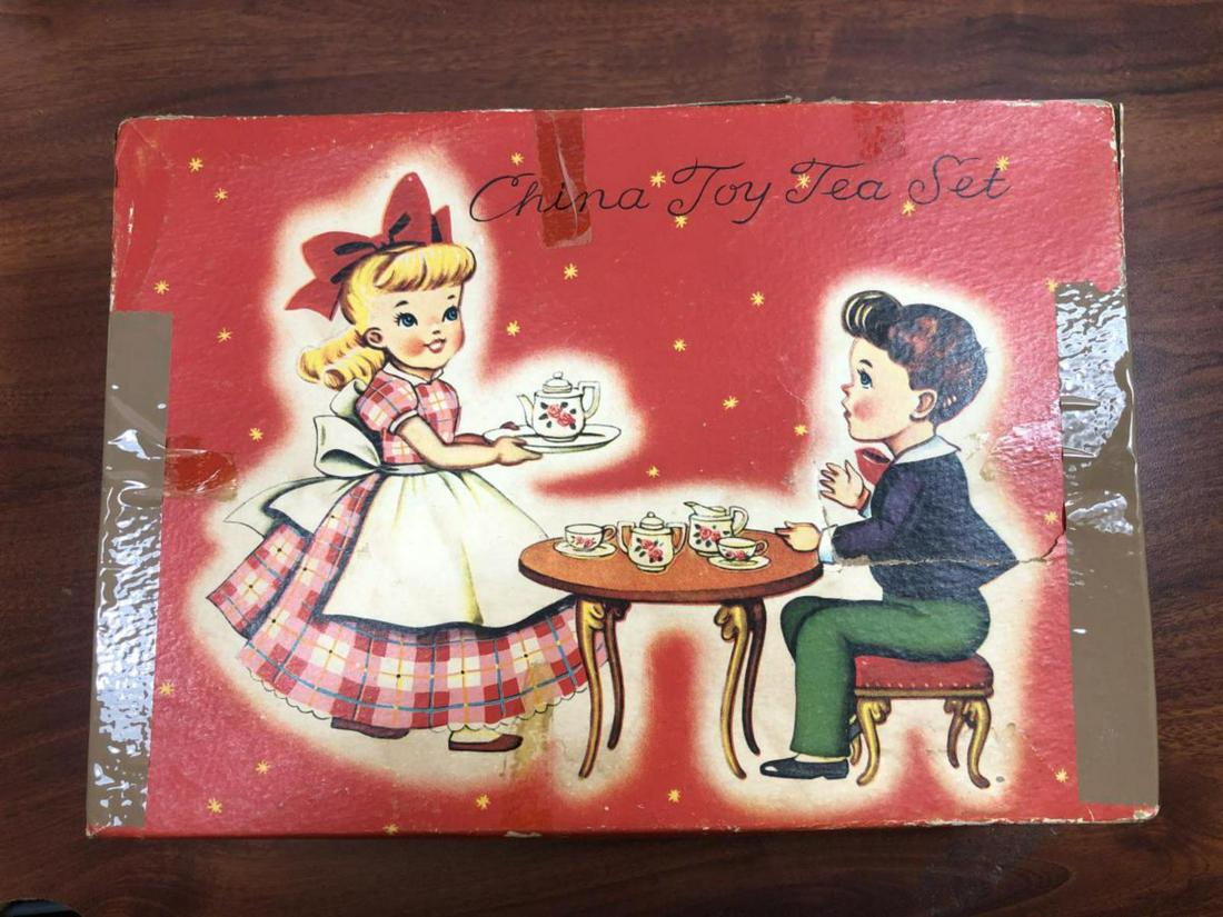 Quaint Vintage Doll China Toy Tea Set in Box: Quaint Vintage Doll China Toy Tea Set in Box consists of 4 plates (3 3/8"), 4 saucers (2 3/4"), 4 cups, Tea Pot with Lid, Sugar Bowl, and Creamer with Lid. Housed in the original box which does have s