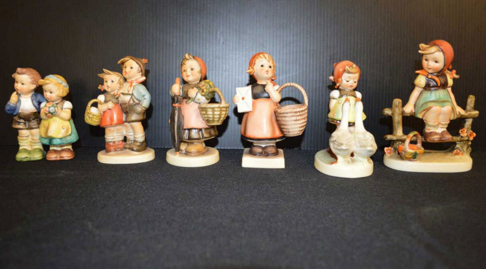 Lot Of Hummels: Lot Of Hummels. Total of 6 in the lot. Consists of #350 on Holiday Tmk 6. Meditation Tmk 4. # 94 3/0 Surprise Tmk 5. #214 E/I We congratulation Tmk 7, #47 2/0 Goose Girl Tmk 6. #112/I Just Resting Tmk