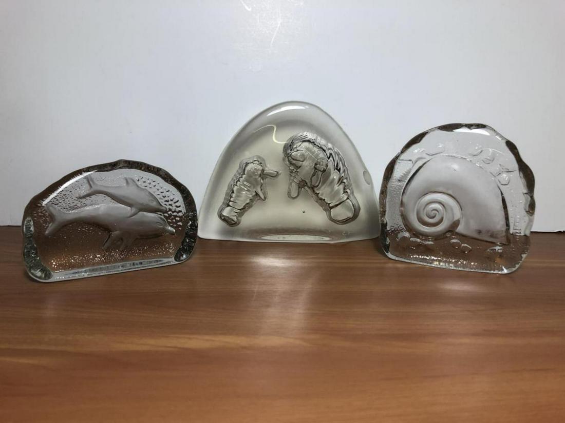 Glass Paperweight Trio Manatees Dolphin Shell: Beach Related Glass Paperweight Trio includes a Momma and Baby Manatee, a Pair of Dolphins, and a Shell. They range from to 3.5” x 3.5” to 6” x 4”. The manatee one is artist signed C. Boerx. N
