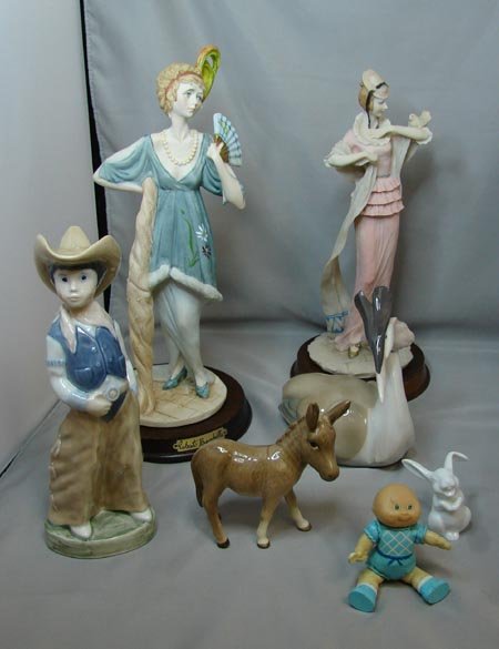 Lot of Figurines incl. Beswick Donkey: Lot of figurines including two lady's fashionably dressed approx.11" tall, a Beswick donkey, Bing & Grondal cowboy, Rosenthal rabbit, cabbage patch baby and a funny looking bird.