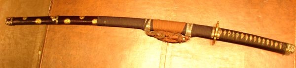 Brass Japanese Katana Sword 100 yrs old: 100 years old Japanese Brass Katakan Sword, Signed, nice blade, black saya with gold; sword 44" long, blade 30 3/4".