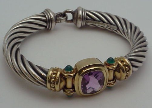David Yurman 14k/ss cuff bracelet: David Yurman 14k and sterling colored stone cuff bracelet weighing 53.2 grams. Bracelet contains 13x12mm cushion cut amethyst with 4 bullet emeralds. Bracelet has large lobster claw clasp .