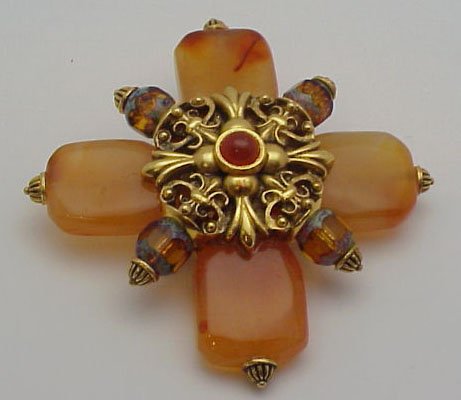 Jose Barrera colored stone pin: Gold tone and colored stone pin from designer Jose Barrera with gold filigree and bead work.