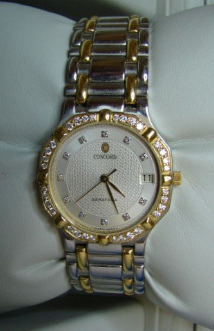 Lady's Concord Saratoga watch has diamond bezel w: Lady's Concord Saratoga watch has diamond bezel with stainless steel diamond dial. Watch has original box and papers.