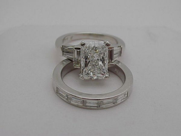 Lady's platinum diamond bridal set weighing 12.7: Lady's platinum diamond bridal set weighing 12.7 grams. Rings contain one radiant diamond weighing 2.51ct with SI2 clarity G color. Engagement and wedding band contain 11 baguette diamonds 1.25ctw. Fi