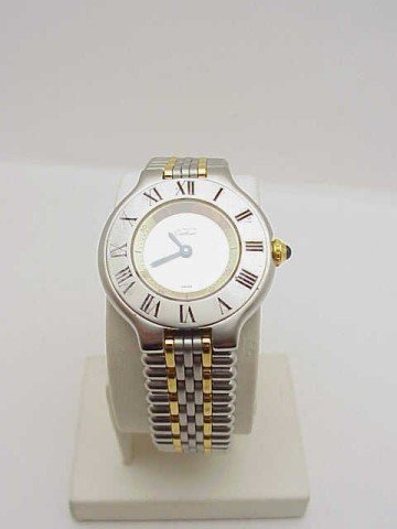 Lady's Must de Cartier roman watch: Lady's stainless and gold tone Cartier Roman watch. Watch is swiss made, water resistant and has panther link bracelet with sapphire crown.