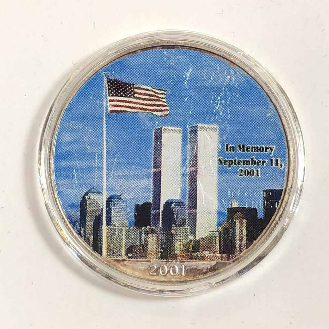2001 Silver Eagle Colorized In Memory 9-11 WTC: 2001 Silver Eagle Colorized In Memory 9-11 WTC. Obverse features the World Trade Center, with In Memory September 11, 2001, as the reverse features a furled flag with God Bless America, colorized on 2
