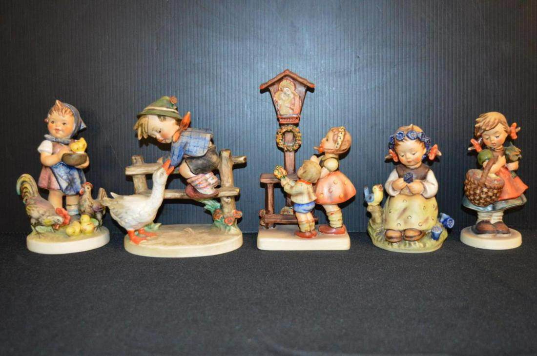Lot Of Hummel Figurines: Lot Of Hummel Figurines. Total of 5 figurines in the lot. Consists of Autumn Harvest #355 Tmk 5. Stands 4 3/4" tall. Adoration #23/1 Tmk 5. Stands 6 1/2" tall. Feeding Time #199/1 Tmk 6. Stands 5 1/2"