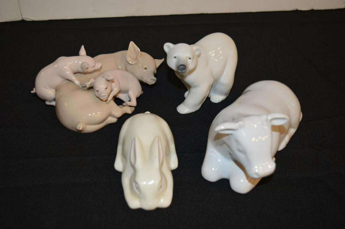 Four Porcelain Animal Figurines Lladro/Belleek: Four Porcelain Animal Figurines. Two Lladros, a polar bear, 4"h. and a pig with piglets, 3 1/4"h., a Belleek rabbit, 2"h. and an unsigned cow, 3 1/2"h.