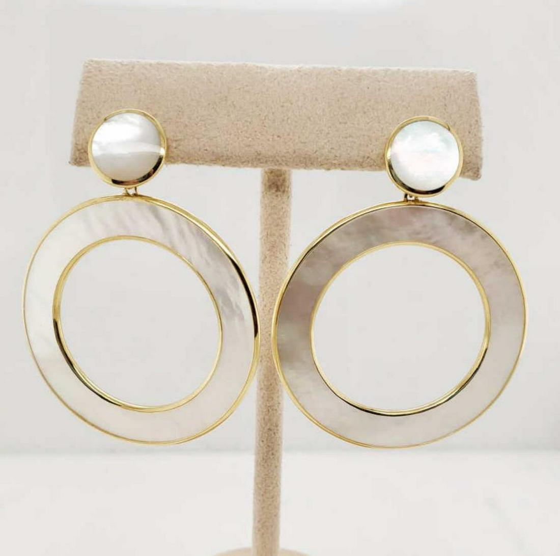 18kt Ippolita Rock Candy Mother of Pearl earrings: Ladies 18kt yellow gold Ippolita Rock Candy Mother of Pearl open circle drop earrings featuring slices of white mother of pearl framed in gold. Length approx. 2". Weight 9.5 grams
