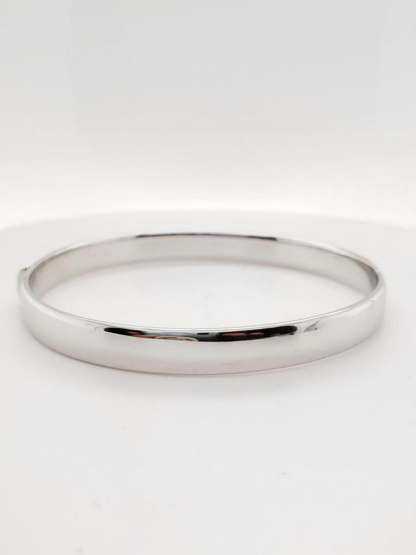18kt white gold Roberto Coin Bangle Bracelet: Ladies 18kt white gold Roberto Coin bangle bracelet . Width 6.5mm. Measures 2.5" in diameter. Weight 13.5 grams. Bracelet does not have a stone mounted on the inside but does carry the Roberto Coin tr