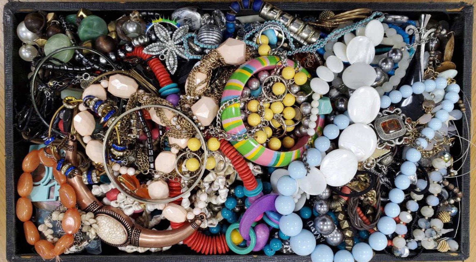 Large lot of costume jewelry: Large lot of costume jewelry featuring bangle bracelets, fancy link chains, dangle earrings, shell necklace, large pendants, buttons, beaded necklaces and more
