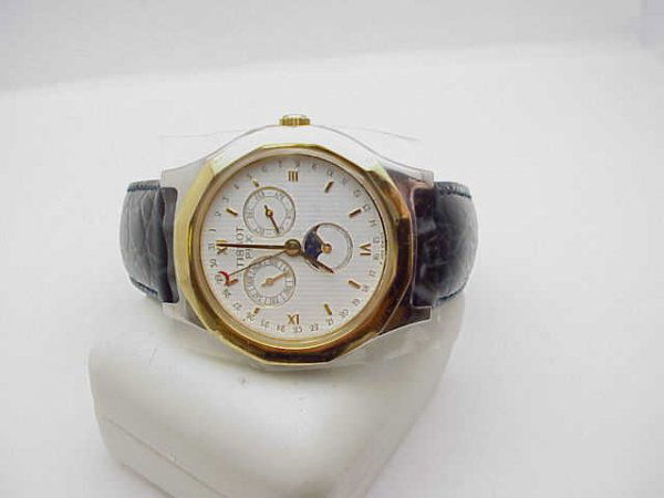 Man's Tissot PRX Moonphase watch: Man's Tissot PRX Moonphase watch is a swiss made chronometer in stainless with goldtone bezel and day date with moonphase. Remember, never been worn!
