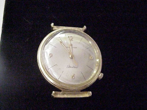 Man's 1950s 14kyg Hamilton electric watch: Man's 14kyg Hamilton electric wrist watch from the early '50s has silver stick dial, plastic crystal, however needs a new band. Is in running condition.