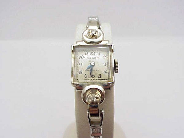 14kwg lady's Gruen diamond watch: Lady's 14kwg Gruen diamond watch weighing 14 grams. This vintage watch has 2 prong set diamonds on the case and diamonds all around the band. Has adjustable clasp and in good running condition.