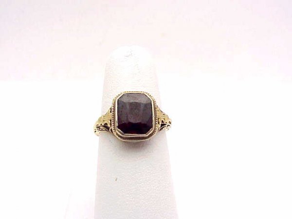 Lady's vintage 14kyg garnet ring: Lady's vintage 14kyg garnet ring weighing 3.1 grams. Ring contains one emerald cut garnet measuring 10X8mm milgrain bezel set. Finger size 61/2.