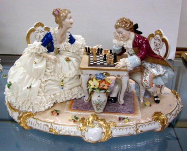 Court Figurine Playing Chess w/Dresden Lace: Antique elaborate hard paste porcelain figurine of a man and woman, in fancy Court Dress, playing chess. Her gown is covered with Dresden Lace. We can see no chips or cracks, the lace is in excellent 