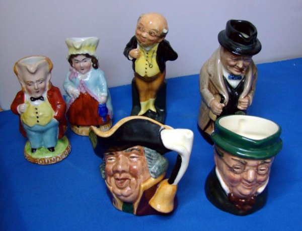 6 Royal Doulton Jugs incl. Winston Churchill: 6 Royal Doulton pieces; Winston Churchill Toby Jug 4" tall, Dickens' Mr. Pickwick figurine, 2 mini Character jugs Mr. Pickwick and Town Crier, and 2 very old Toby Jugs 3 1/4" tall Little Dorrit and Mr