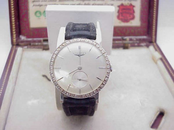 Man's vintage Longine diamond watch: Man's 18k white gold vintage diamond watch weighing 31.3 grams. This watch has a silver stick dial with 1ctw diamond bezel, second hand dial in lower bottom and original leather band and box. Good run