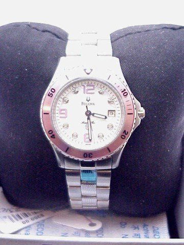 lady's Bulova Marine Star watch/diamonds: Lady's Bulova Marine Star watch with stainless steel case, white mother of pearl diamond dial with calendar and pink bezel and numbers. NEW!