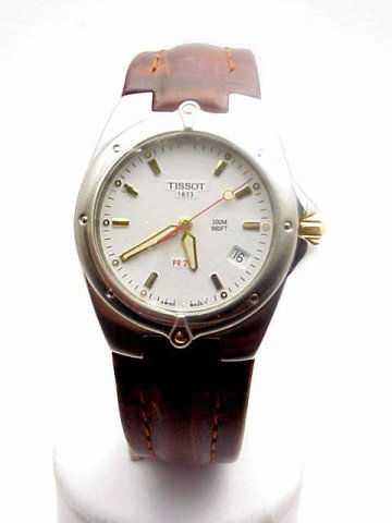 Man's Tissot 2 tone watch with leather band: Man's Tissot 2 tone fashion watch swiss made with white stick dial and date indicator, dive to 200 meters and brown leather band.