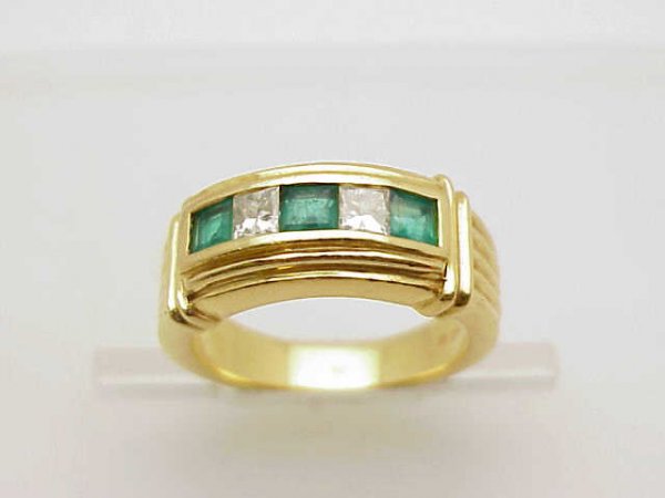 18yg emerald/diamond band: 18kyg emerald and diamond ring weighing 10 grams. This ring contains 3 square cut emeralds with 2 princess cut diamonds invisible set in a bar style ring. Finger size 63/4.