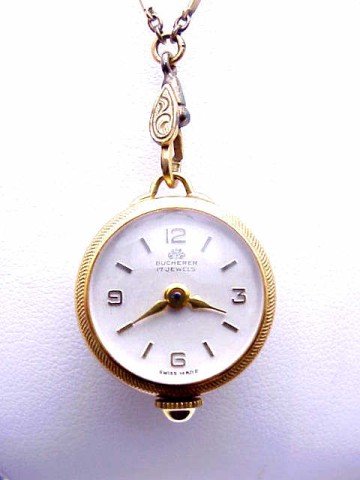 Lady's Bucherer pendant watch: Lady's Bucherer gold plated pendant style watch has 17 jewel wind up movement, transparent back and 28"bar style chain with original box.