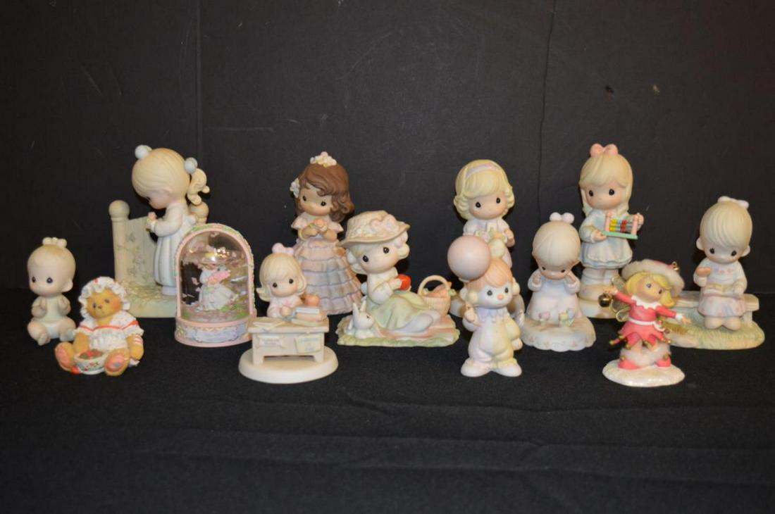 Group of Precious Moments Figurines: Group of Precious Moments Figurines. Twelve figurine including a "snow" globe, 3" to 6"h., also included is a Cherished Teddies figurine, 2 1/4"h.