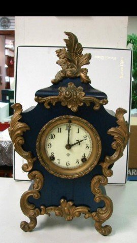 Heavy Blue Metal Ornate Ansonia Mantle Clock: Heavy Blue Metal Ornate Ansonia Mantle Clock, keys are taped to back; not sure if it keeps proper time. Top leaf has been repaired - see photo.