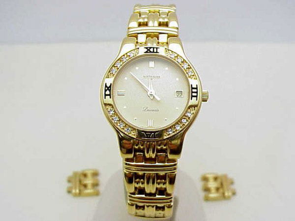 Lady's Wittenhaur Laureate diamond watch: Lady's Wittnauer gold tone Laureate watch swiss made quartz movement, diamond bezel, and hidden clasp. Has extra links.