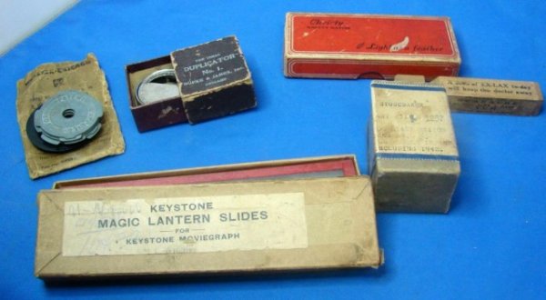 Vintage Lot Misc. 1930/1940 Memorabilia: Studebaker part from 1942, box of magic lantern slides, Ex-Lax advertisement on a piece of wood (not sure what it was used for), Christy safety razor, record adaptors, and "The Ideal Duplicator" ??