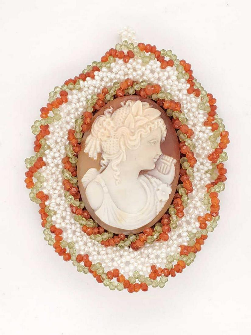 Ladies Carved Cameo Pendant by Carada: Ladies Carved Cameo Pendant by Cameo, featuring a carved cameo depicting a vintage women's profile with harp framed by fresh water pearls and orange and green beads. Width approx. 55mm.