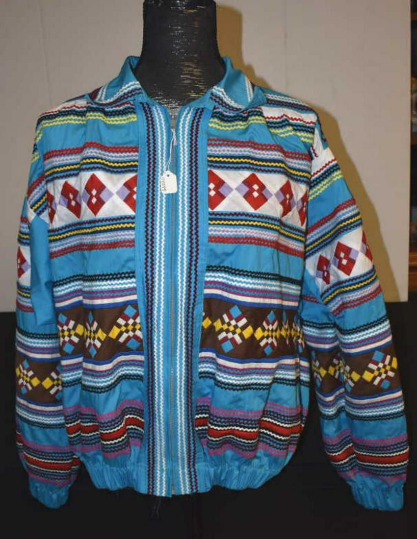 Ladies Miccosukee Hand Stitched Jacket: Ladies Miccosukee or Seminole Hand Stitched Multiple Colored Jacket. Gathered bottom, long sleeved,. conventional collar. likely a size large. 25" from collar to waist. Grey zipper closure. No pockets