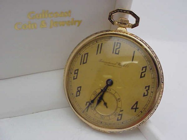 Man's 14k rose gold IWC pocket watch: Man's vintage 14k rose gold IWC Schaffhausen open faced pocket watch with gold dial and inset second hand, black hands, filigree bezel with black enameling, plain back that can be engraved and in good