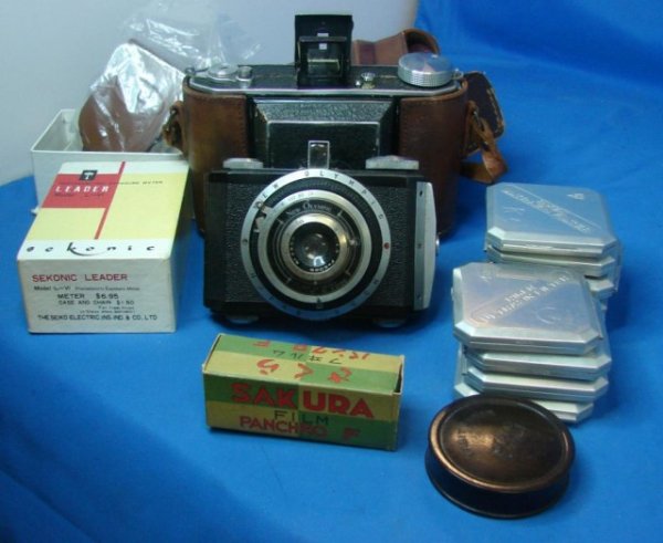 4 WWII Lighters & Vintage Cameras & Accessories: 4 WWII Lighters & 2 Vintage Cameras, 1 Olympus Tokyo with leather case embossed Zeiss Ikon, and the other is a New Olympic plus Accessories