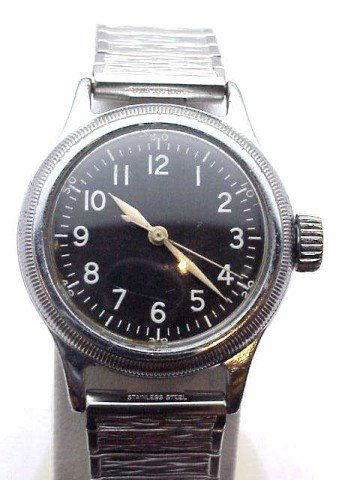 Man's stainless Bulova U.S. Army watch: Man's vintage U.S. Army watch made by Bulova Corp. stainless steel with black dial, mechanical movement and Speidel band. Part #10AK CSH Order #13869.