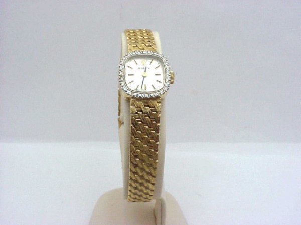 Lady's 14kyg Rolex Cellini dress diamond watch: Lady's 14kyg Rolex Cellini diamond dress watch weighing 24.6 grams with 17 jewel hand wind movement, white stick dial, 29 single cut diamonds .15ctw and basket weave design band(needs some repair).
