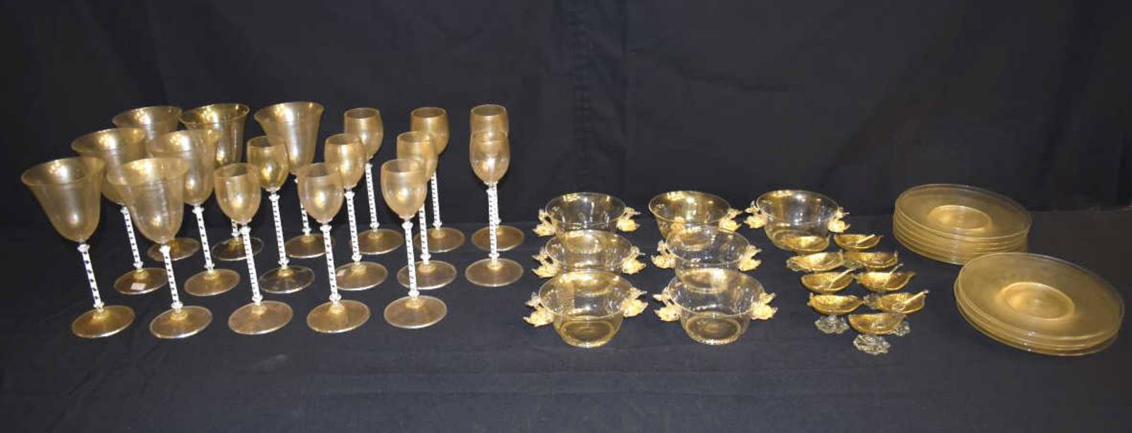 Set of Salviati Murano Stemware, Bowls and Plates: Set of Salviati Murano Stemware. Gold dusted base and bowls with white candy striped stems. Seven wines, 9"h., ten flutes, 8 1/2"h., seven bowls with applied dolphin handles, 2 1/2"h., eleven plates, 