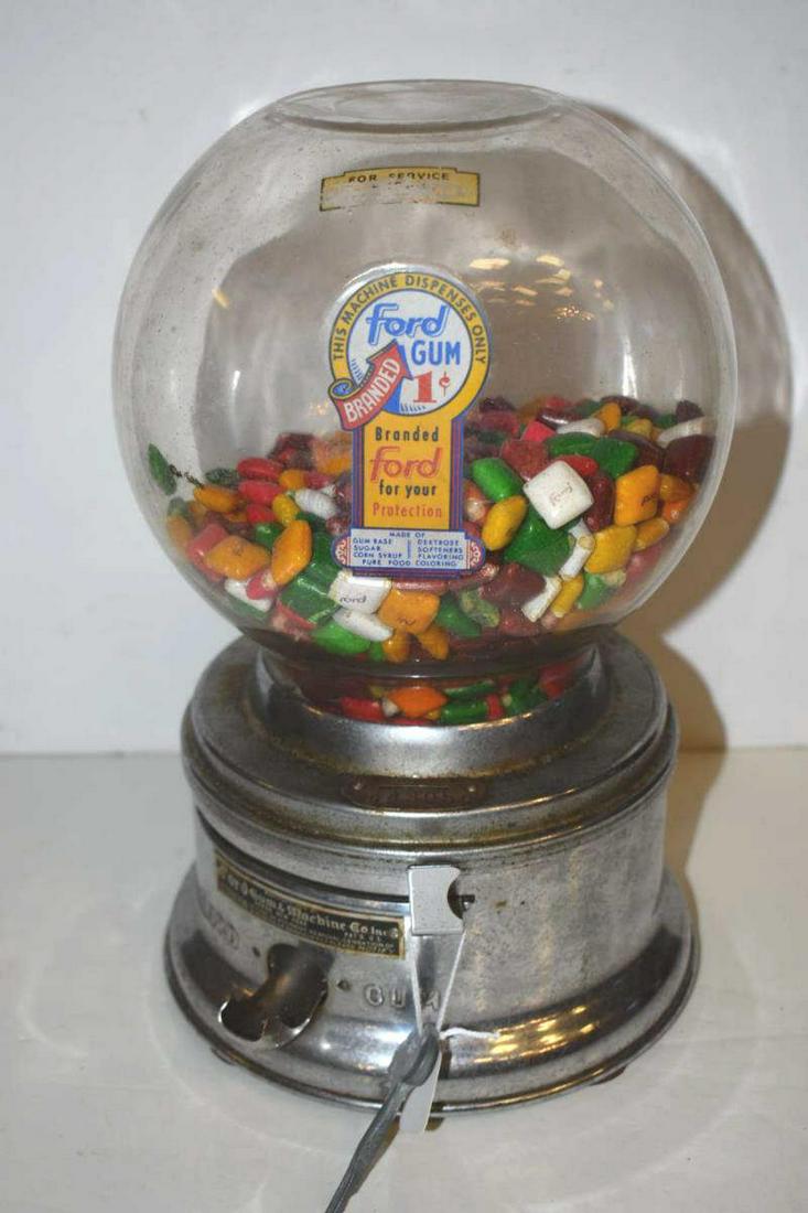 Ford Gumball Machine: Ford Gumball Machine. One cent counter top with chrome base and original name plate and glass globe, includes key, 11"h.