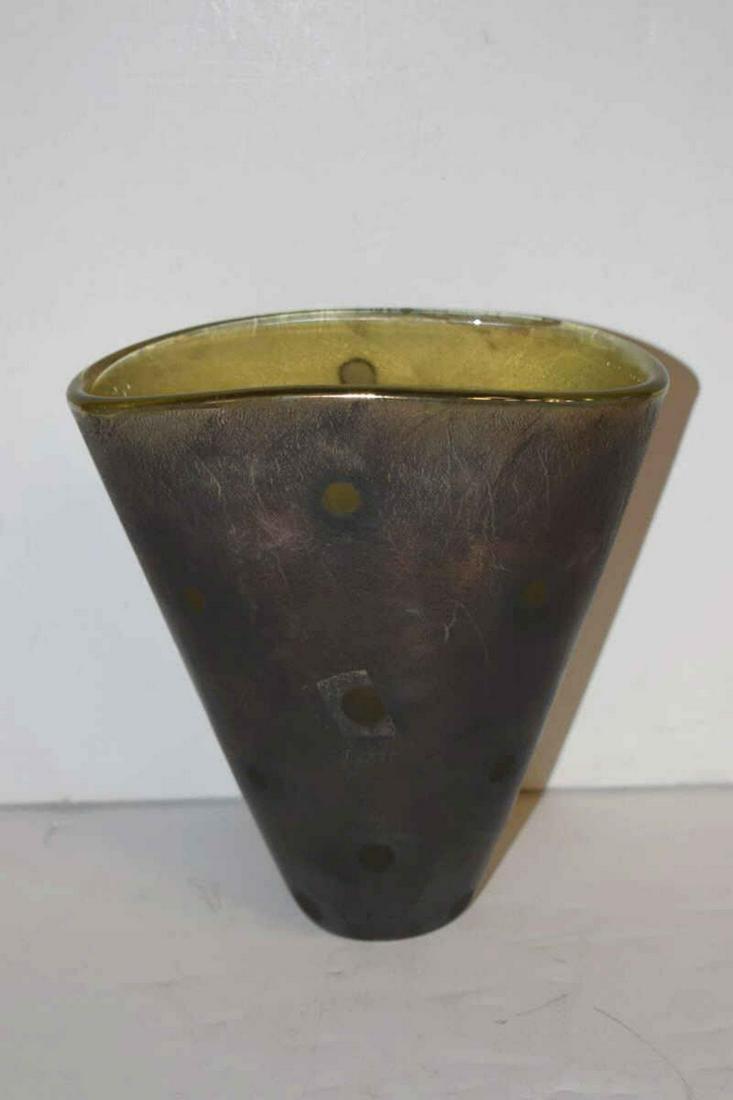Al Arnits Hand Signed Art Glass Vase: Al Arnits Hand Signed Art Glass Vase. Mustard colored semi-translucent glass with a brown-grey outer skin with a crazed or crackled or distressed appearance. Tapered sides 7" tall, 6.5" wide, 3.25" de