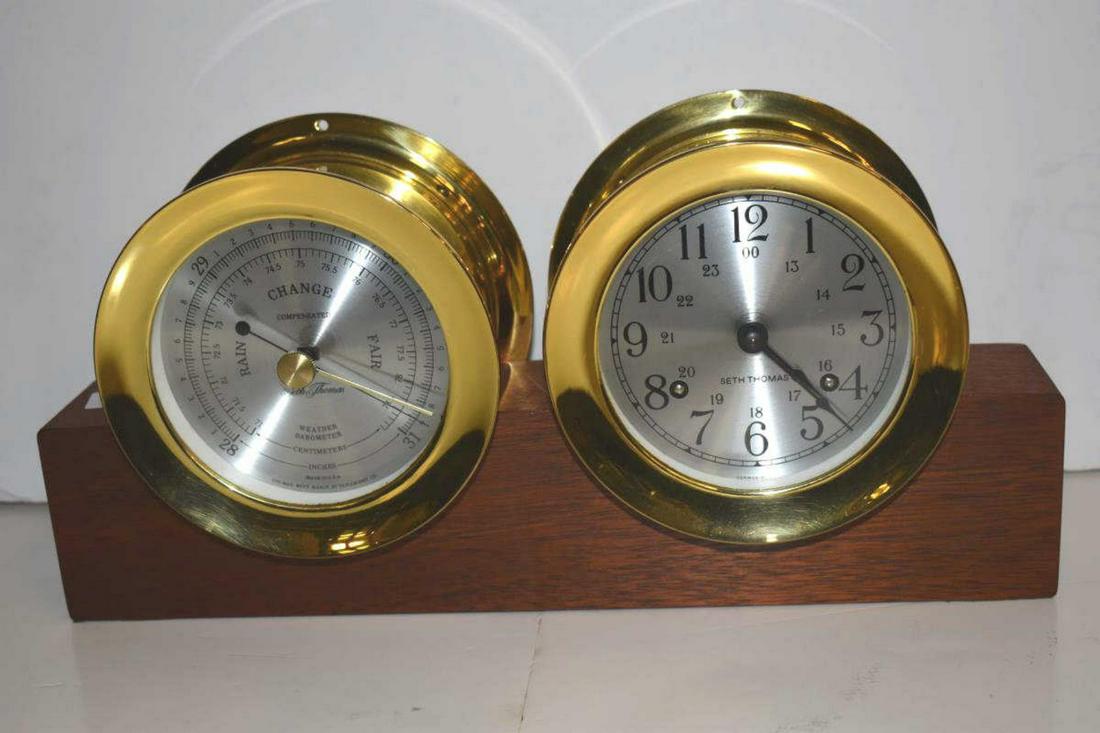 Seth Thomas Corsair Ship's Clock and Barometer Set: Seth Thomas Corsair Ship's Clock and Barometer Set. Brass set with tin dials and fastened to a mahogany base to serve as a desk set, 6 3/4"h. 14"w.