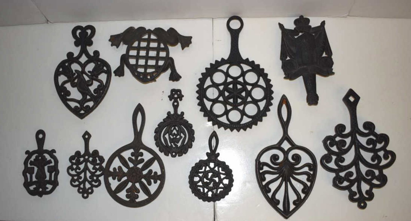 Group of Cast Iron Trivets: Group of Cast Iron Trivets. Twelve trivets of various forms, 5" to 9"l.