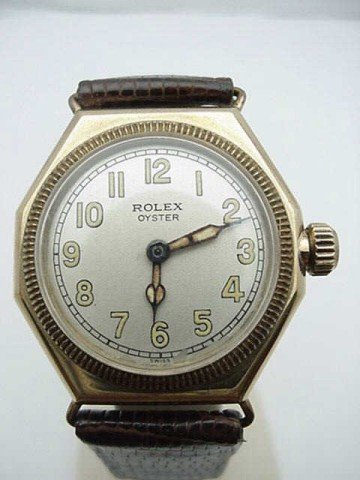 Vintage 1920s Rolex Oyster watch: Vintage 1920s Rolex Oyster watch with octagon shaped case in 14kyg, silver dial, original Rolex crown, and lizard skin band. Needs some movement work. Serial#260554